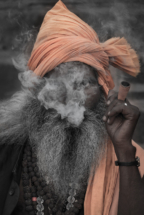 Smoking man, sadhu on Ganges river, Varanasi