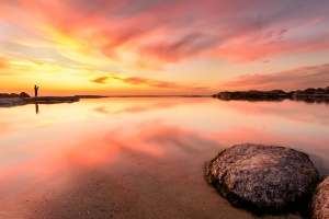 Photographer in beautiful pink sunset, Cape Town