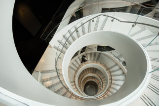 Man walking down a beautiful spiral staircase, Boston 