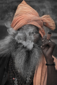 Intense Smoking man, sadhu on Ganges river, Varanasi