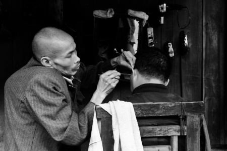 Ear Cleaner A hunchback cleans a mans ears in a Chinese teahouse