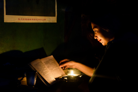 By Candlelight Portrait of Chinese woman reading by candlelight