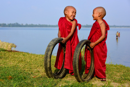 Shiny Happy Little People Candid Shot of 2 monk siblings playing, Myanmar