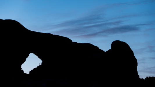 Canyonlands, USA Tiny person inside the arch, Canyonlands, USA